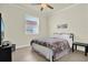 Bedroom featuring tile floors, bright window, and comfortable bed at 2795 Westyn Cove Ln, Ocoee, FL 34761
