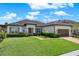 Well-kept single-story home with lush green lawn and neatly trimmed shrubbery at 2795 Westyn Cove Ln, Ocoee, FL 34761