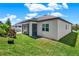 Back exterior view of home with a screened porch and well-maintained lawn, offering a relaxing outdoor area at 2795 Westyn Cove Ln, Ocoee, FL 34761