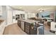 Modern kitchen with granite island, stainless steel appliances, and breakfast bar overlooking living area at 2795 Westyn Cove Ln, Ocoee, FL 34761