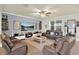 Bright and airy living room with a large TV, comfortable seating, and modern decor at 2795 Westyn Cove Ln, Ocoee, FL 34761