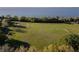 Expansive recreational field with baseball diamond, soccer goal, and lush greenery against a backdrop of serene lake views at 2795 Westyn Cove Ln, Ocoee, FL 34761