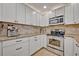 Stylish kitchen featuring stainless steel appliances and white cabinetry at 303 W Par St, Orlando, FL 32804