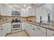 Updated kitchen with stainless steel appliances and tile backsplash at 303 W Par St, Orlando, FL 32804