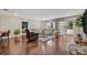 Bright living room featuring dark wood floors, a large sectional sofa, and sliding doors to the outdoor pool area at 303 W Par St, Orlando, FL 32804