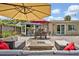 Inviting outdoor patio with seating area, fire pit, and dining area, and an outdoor bar at 303 W Par St, Orlando, FL 32804