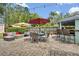Inviting patio area with outdoor seating, dining table, bar, grill, and mature landscaping at 303 W Par St, Orlando, FL 32804