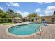 Beautiful in-ground swimming pool with brick paver surround, outdoor furniture, and lush landscaping at 303 W Par St, Orlando, FL 32804