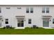 New townhome exterior showing the white back side with a sliding glass door and air conditioner at 3239 Laurent Loop, Davenport, FL 33837