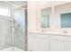 Modern bathroom featuring a tiled shower, dual sinks with modern fixtures, and plenty of counter space at 3239 Laurent Loop, Davenport, FL 33837