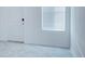 Bright entryway featuring neutral tile flooring, a window with blinds, and a secure smart lock on the front door at 3239 Laurent Loop, Davenport, FL 33837