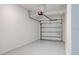 Garage with bright white walls, gray epoxy floor, and white garage door at 3239 Laurent Loop, Davenport, FL 33837