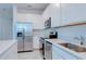 Modern kitchen with white cabinets, stainless steel appliances, and a sleek island with stone countertops at 3239 Laurent Loop, Davenport, FL 33837
