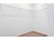 Walk-in closet features white wire shelving, neutral carpet, and white baseboards and walls at 3239 Laurent Loop, Davenport, FL 33837