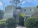 Inviting condominium exterior featuring well-maintained landscaping and a charming stairway entrance at 330 Scottsdale Sq # 330, Winter Park, FL 32792
