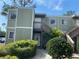 Inviting condominium exterior featuring well-maintained landscaping and a charming stairway entrance at 330 Scottsdale Sq # 330, Winter Park, FL 32792