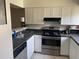 Efficient kitchen featuring white cabinets, updated appliances, and ample countertop space at 330 Scottsdale Sq # 330, Winter Park, FL 32792