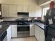 Efficient kitchen featuring white cabinets, updated appliances, and ample countertop space at 330 Scottsdale Sq # 330, Winter Park, FL 32792