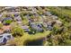 Aerial view of a neighborhood with many houses, green grass and mature trees at 3418 Turningwind Ln, Winter Garden, FL 34787