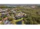 A beautiful neighborhood aerial view with mature trees and a pond at 3418 Turningwind Ln, Winter Garden, FL 34787