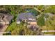 An aerial view of a beautiful home featuring a pond, manicured landscaping, and mature trees at 3418 Turningwind Ln, Winter Garden, FL 34787