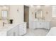 Elegant bathroom boasting dual vanities, marble countertops, and modern fixtures at 3418 Turningwind Ln, Winter Garden, FL 34787