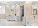 Luxurious bathroom with dual vanities, marble countertops, and a glass enclosed shower at 3418 Turningwind Ln, Winter Garden, FL 34787
