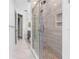 Long bathroom featuring glass shower enclosure, modern fixtures, and tile flooring at 3418 Turningwind Ln, Winter Garden, FL 34787