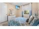 Bright bedroom featuring a white dresser, large window, and a comfortable queen-size bed at 3418 Turningwind Ln, Winter Garden, FL 34787