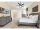 Spacious bedroom with neutral tones, large windows, and two dressers at 3418 Turningwind Ln, Winter Garden, FL 34787