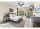 Bright bedroom featuring a neutral color palette, large windows, and outdoor access at 3418 Turningwind Ln, Winter Garden, FL 34787