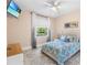 Inviting bedroom with a mounted TV, natural light and comfortable bed at 3418 Turningwind Ln, Winter Garden, FL 34787