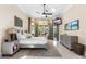 Bright bedroom featuring a neutral color palette, large windows, and balcony access at 3418 Turningwind Ln, Winter Garden, FL 34787