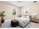 Bright bedroom with a neutral palette, featuring a comfortable bed, area rug, and a ceiling fan at 3418 Turningwind Ln, Winter Garden, FL 34787