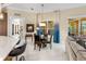 Bright dining area with large windows, elegant curtains, and direct access to the outdoor living space at 3418 Turningwind Ln, Winter Garden, FL 34787