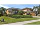 Stunning home with meticulously maintained landscaping, lush green lawn, and beautiful architectural details at 3418 Turningwind Ln, Winter Garden, FL 34787
