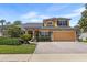 Beautiful two-story home with a manicured lawn, stone accents, and attached two-car garage at 3418 Turningwind Ln, Winter Garden, FL 34787