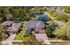 An aerial view of a grand two-story home with a three-car garage, mature trees, and a large lawn at 3418 Turningwind Ln, Winter Garden, FL 34787