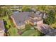 Aerial view of a beautiful two-story home with mature landscaping, a three-car garage and an attractive facade at 3418 Turningwind Ln, Winter Garden, FL 34787