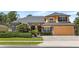 Charming home featuring stone accents, manicured landscaping, and an attached two-car garage at 3418 Turningwind Ln, Winter Garden, FL 34787