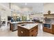 An open-concept kitchen with an island, stainless steel appliances, and seamless transition to the living space at 3418 Turningwind Ln, Winter Garden, FL 34787