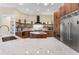 A modern kitchen with custom wood cabinetry, stainless steel appliances, and a marble countertop island at 3418 Turningwind Ln, Winter Garden, FL 34787