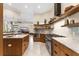 Spacious kitchen boasts an island, stainless steel appliances, and custom cabinetry with ample counter space at 3418 Turningwind Ln, Winter Garden, FL 34787