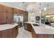 Open kitchen design featuring marble countertops, stainless steel appliances, and a double-door refrigerator at 3418 Turningwind Ln, Winter Garden, FL 34787