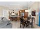 Modern kitchen with marble countertops, stainless steel appliances, and breakfast bar overlooking the dining area at 3418 Turningwind Ln, Winter Garden, FL 34787