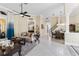 Spacious living room open to the dining area, featuring neutral walls and tile flooring at 3418 Turningwind Ln, Winter Garden, FL 34787