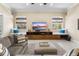 Inviting living room with cozy seating, custom built-in entertainment center, and natural light from the windows at 3418 Turningwind Ln, Winter Garden, FL 34787