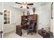 Well-lit home office featuring a wooden desk, built-in shelving, and a comfortable executive chair at 3418 Turningwind Ln, Winter Garden, FL 34787
