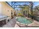 Inviting screened-in pool area with barbecue, tropical plants, string lights, and plenty of room to relax at 3418 Turningwind Ln, Winter Garden, FL 34787