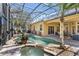 Beautiful pool area with tropical landscaping, hot tub and outdoor dining and lounge areas at 3418 Turningwind Ln, Winter Garden, FL 34787